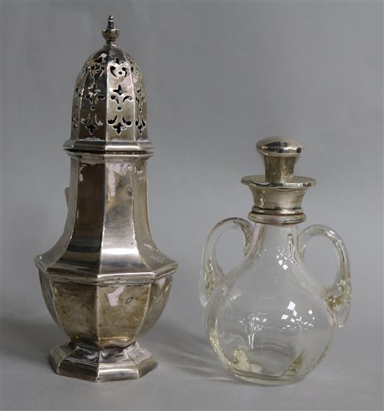 A George V silver mounted two handled glass whisky tot jug and stopper, London, 1921 and a silver sugar caster.